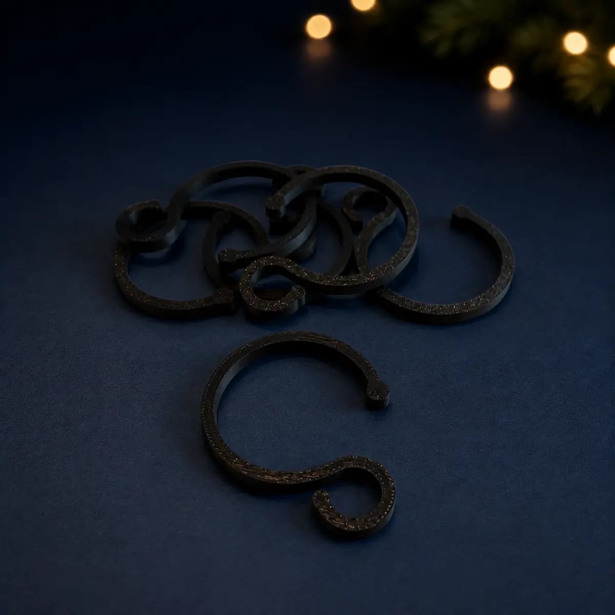 Black 3D-printed Christmas light hanger for a 40 mm pipe