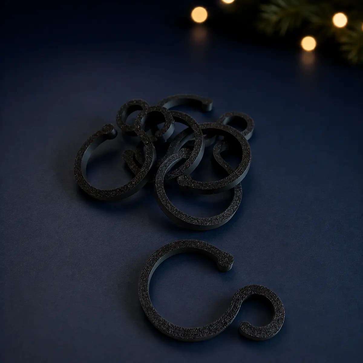 Black 3D-printed Christmas light hanger for a 35–38 mm pipe