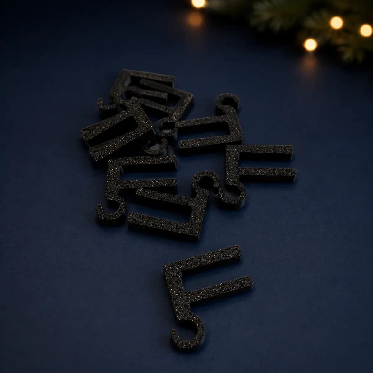Black 3D-printed Christmas light hanger for a 6 mm glass railing