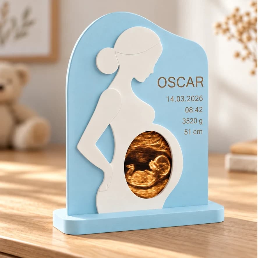 Lyseblå ramme til scanningsbillede med hvid gravid silhuet og navnet OSCAR med fødselsdata
